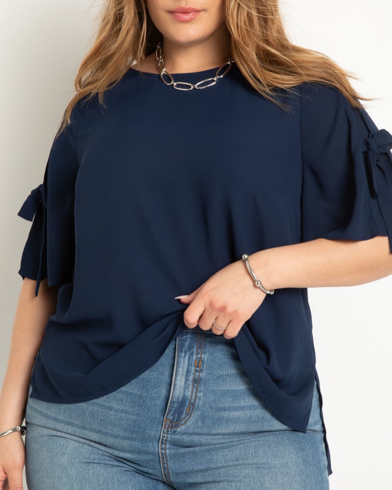 Front of a model wearing a size 24 Relaxed Top With Tie Sleeve in Navy by ELOQUII. | dia_product_style_image_id:300075